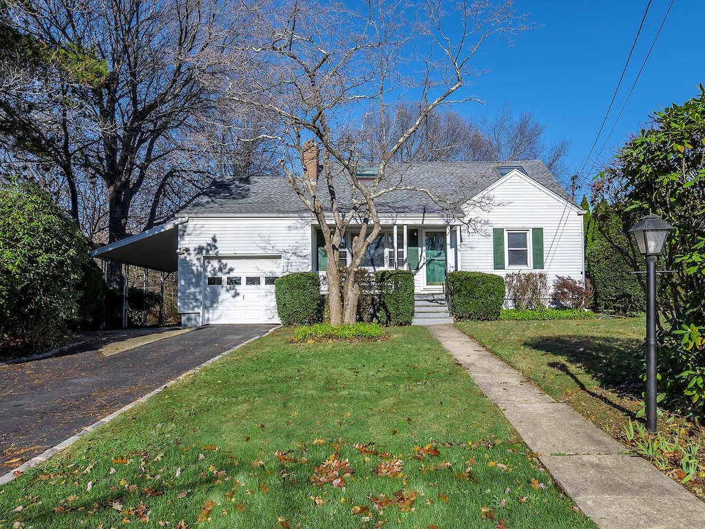 view of front of property with a front yard and a carport