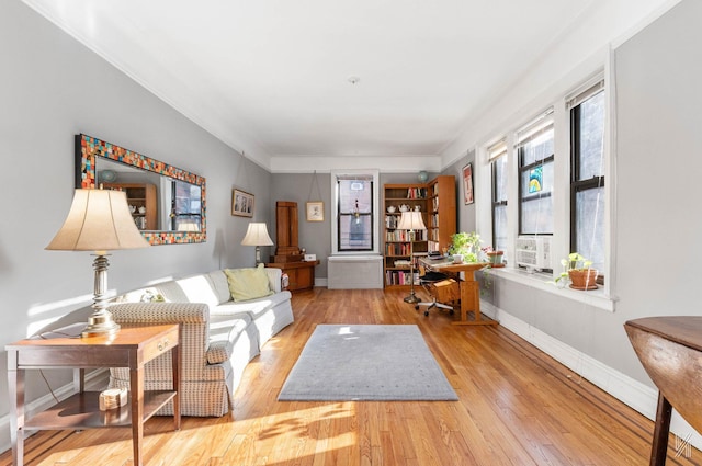 living room with light hardwood / wood-style flooring and crown molding