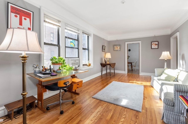 interior space featuring light wood-type flooring, cooling unit, and ornamental molding