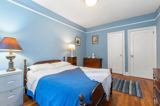 bedroom featuring dark wood-type flooring