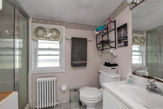 bathroom with radiator, tile patterned flooring, an enclosed shower, toilet, and vanity