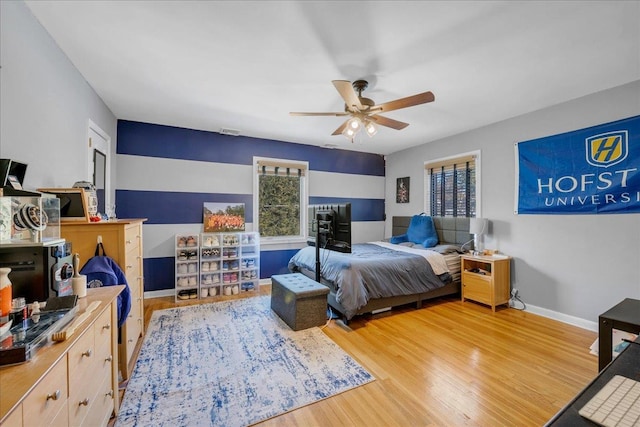 bedroom with light hardwood / wood-style flooring and ceiling fan