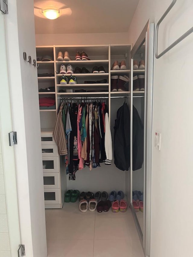 walk in closet featuring tile patterned flooring