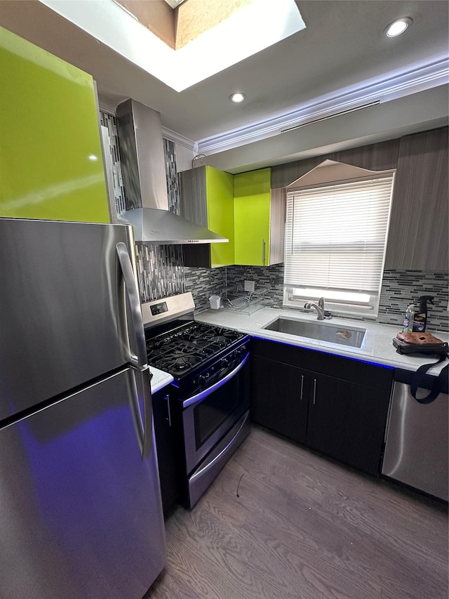 kitchen featuring sink, range hood, light hardwood / wood-style floors, decorative backsplash, and appliances with stainless steel finishes