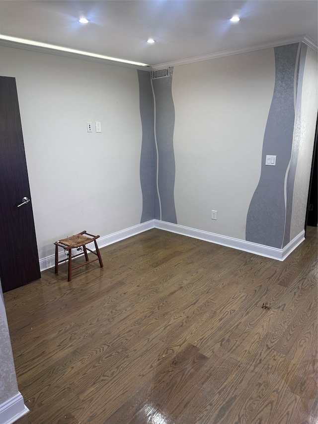 unfurnished room with dark hardwood / wood-style flooring and ornamental molding