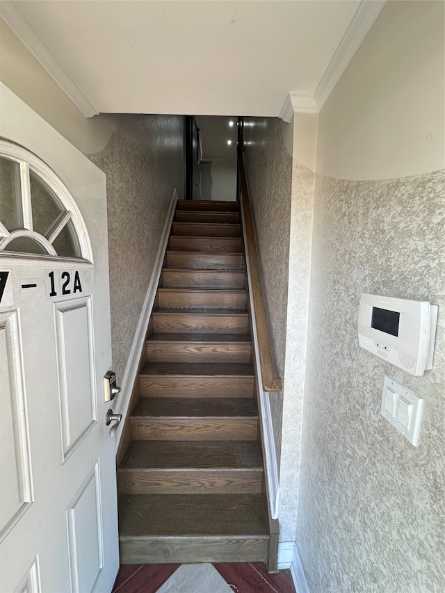 stairway featuring hardwood / wood-style flooring and ornamental molding