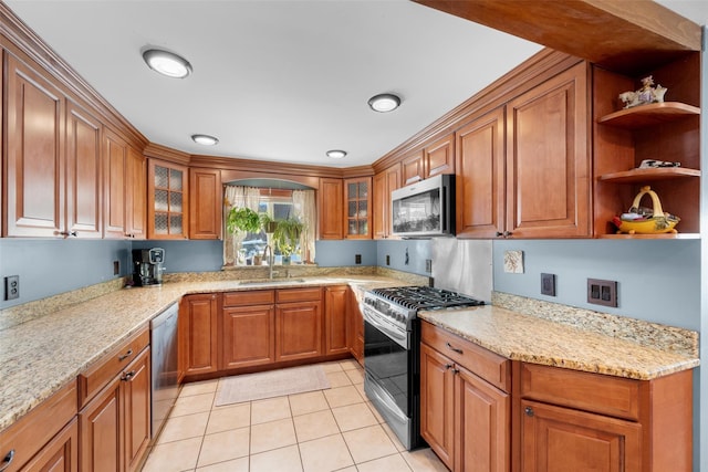 kitchen with light stone countertops, light tile patterned floors, stainless steel appliances, and sink