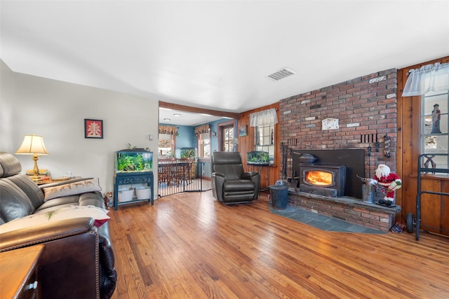 living room featuring a wood stove and hardwood / wood-style flooring