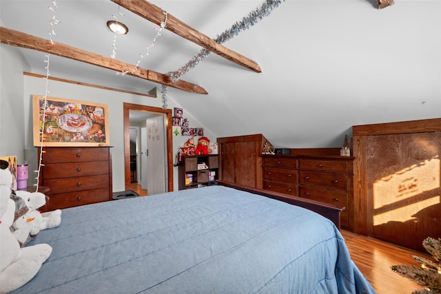 bedroom featuring lofted ceiling with beams and hardwood / wood-style flooring