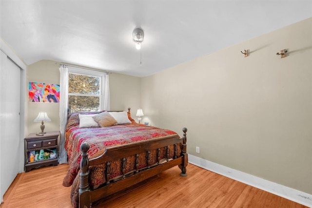 bedroom featuring vaulted ceiling and hardwood / wood-style flooring