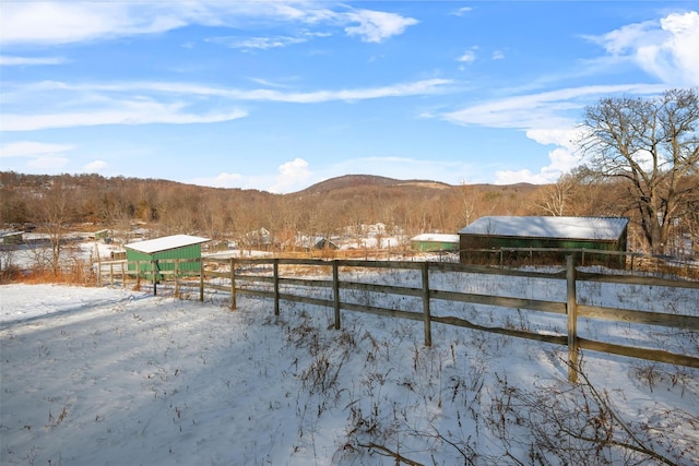 snowy yard featuring a mountain view