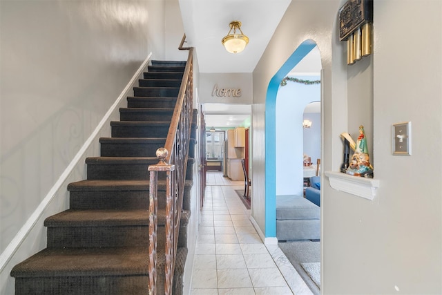 stairway featuring tile patterned flooring