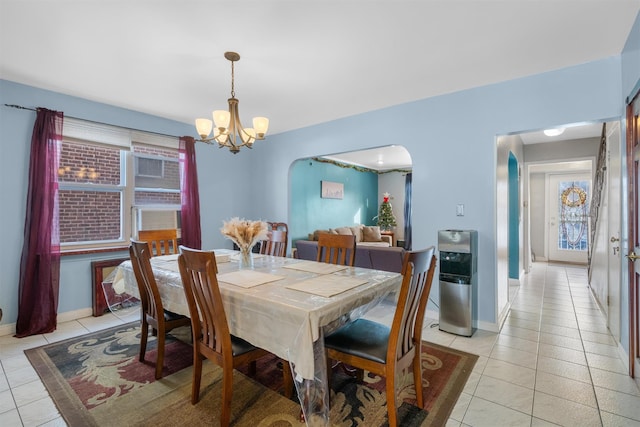 tiled dining area featuring an inviting chandelier