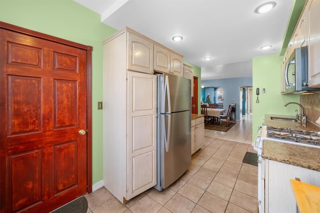 kitchen featuring sink, light tile patterned floors, and stainless steel appliances