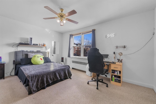 bedroom with ceiling fan and radiator heating unit