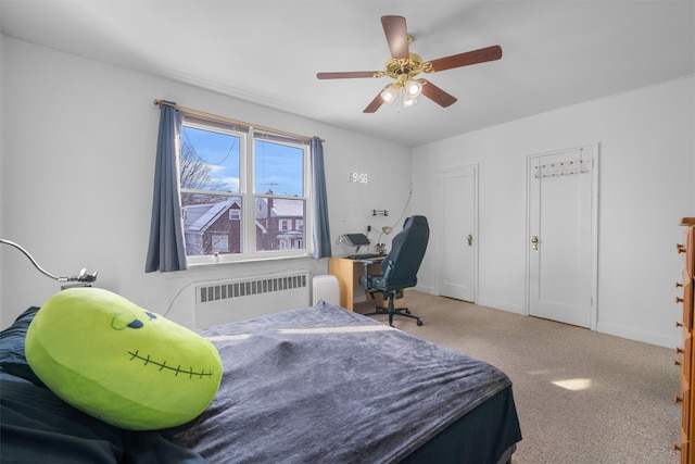 bedroom featuring carpet, ceiling fan, and radiator heating unit