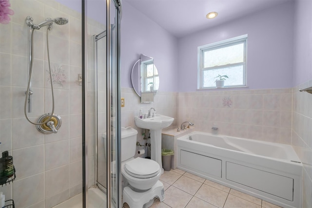 full bathroom featuring tile patterned floors, sink, toilet, shower with separate bathtub, and tile walls