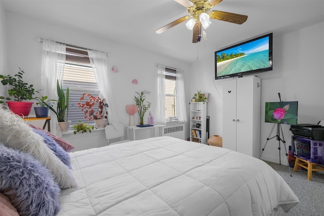 bedroom featuring ceiling fan, radiator heating unit, and light carpet