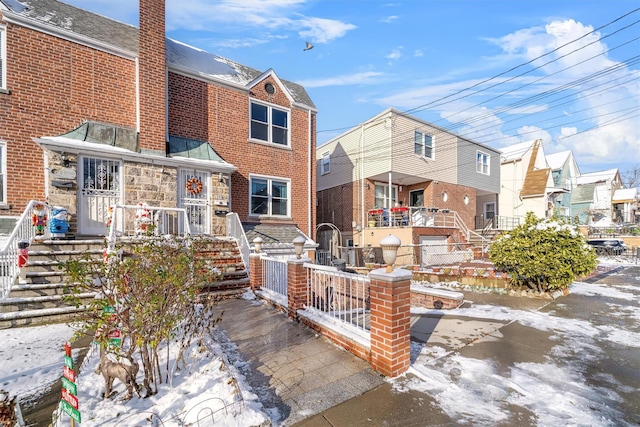 view of snow covered rear of property