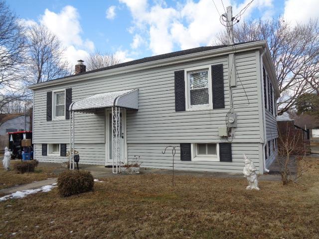 bi-level home with a front lawn