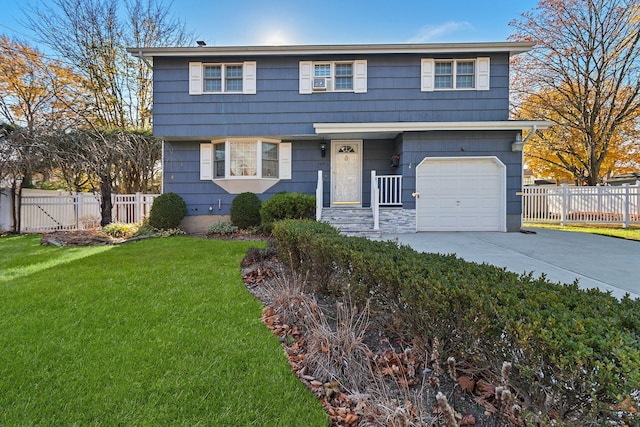 view of front of house with a garage and a front yard