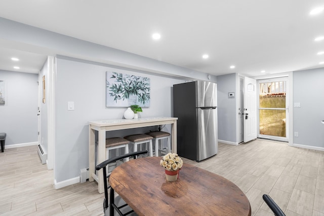 dining space with a baseboard heating unit