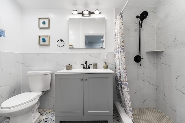 bathroom with toilet, vanity, tile walls, and a shower with shower curtain