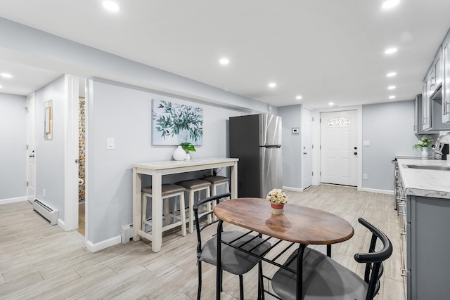 dining space featuring a baseboard heating unit