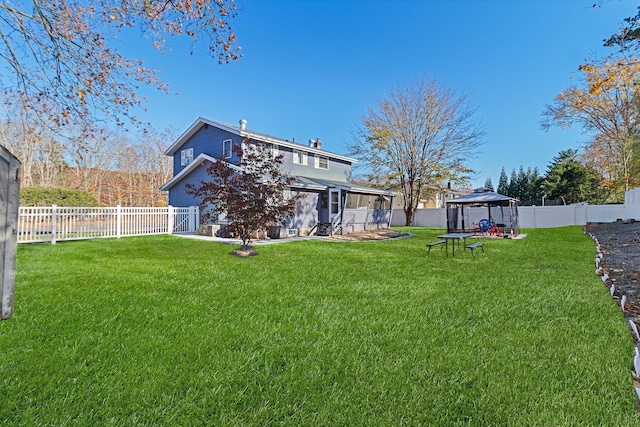 view of yard with a gazebo and a sunroom