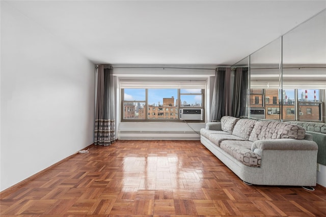 unfurnished living room featuring parquet floors, cooling unit, and a baseboard heating unit