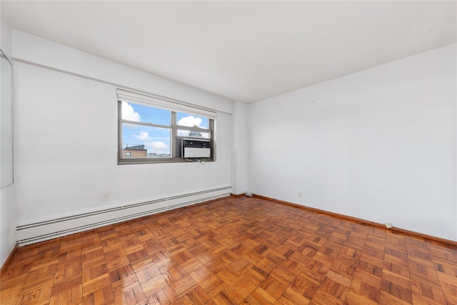 unfurnished room with parquet flooring and a baseboard heating unit