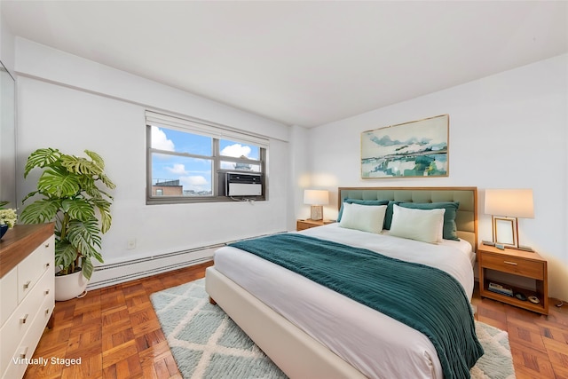 bedroom with baseboard heating and parquet floors