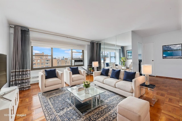 living room featuring a baseboard heating unit and parquet floors