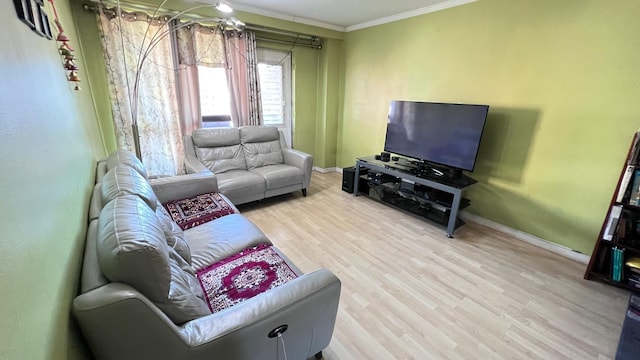 living room with light hardwood / wood-style flooring and crown molding