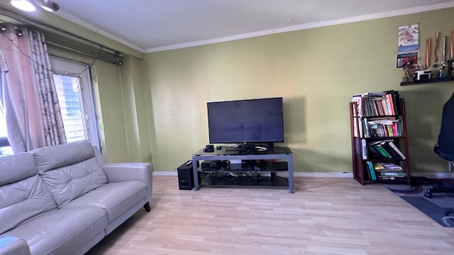 living room with light hardwood / wood-style floors and ornamental molding