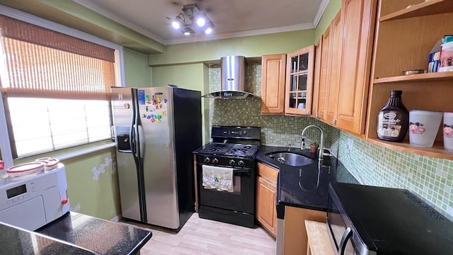 kitchen featuring black gas stove, wall chimney range hood, crown molding, sink, and stainless steel fridge