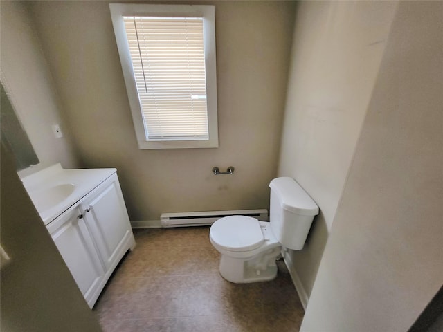 bathroom with tile patterned floors, vanity, a baseboard heating unit, toilet, and plenty of natural light