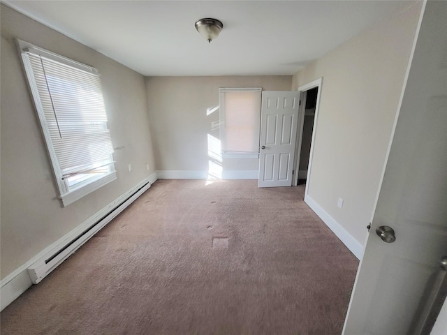 unfurnished room featuring carpet flooring and a baseboard radiator