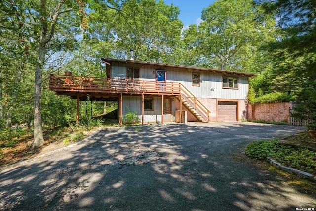 view of front of home with a garage and a wooden deck