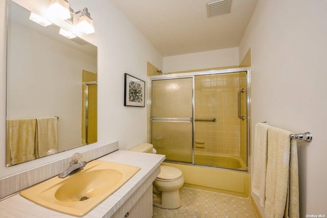 full bathroom with toilet, bath / shower combo with glass door, tile patterned floors, and vanity