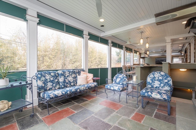 sunroom / solarium with beam ceiling, ceiling fan, and wooden ceiling