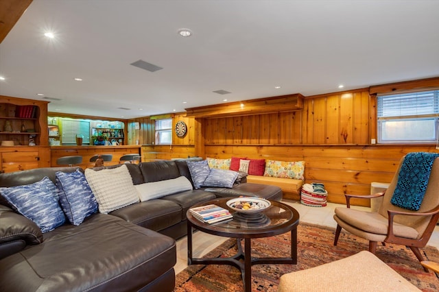 living room featuring tile patterned flooring and wooden walls