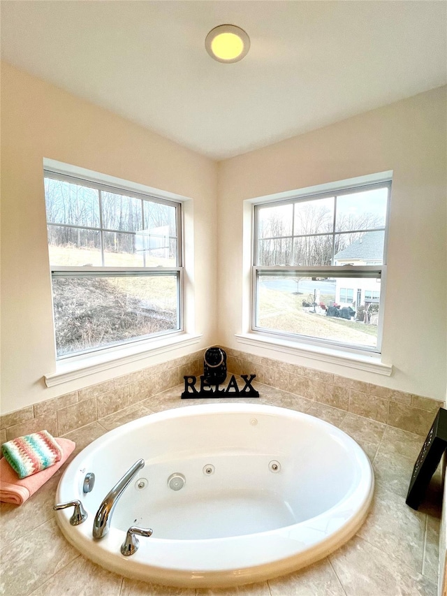 bathroom with tiled bath and plenty of natural light