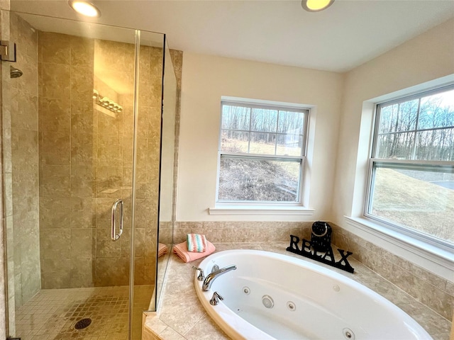 bathroom featuring a healthy amount of sunlight and separate shower and tub