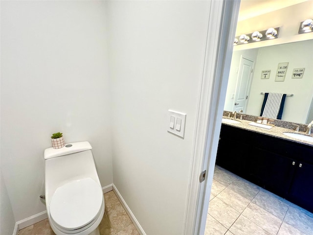 bathroom featuring tile patterned flooring, vanity, and toilet