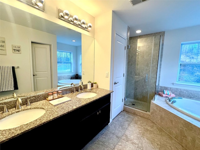 bathroom featuring independent shower and bath, tile patterned flooring, and vanity