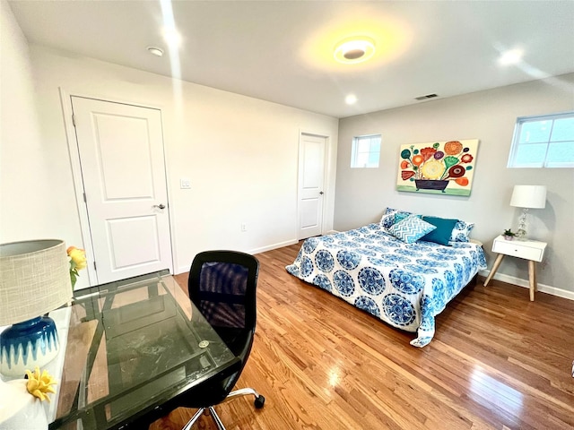 bedroom with hardwood / wood-style floors