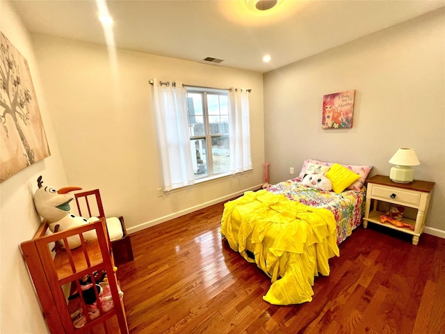 bedroom with dark hardwood / wood-style floors