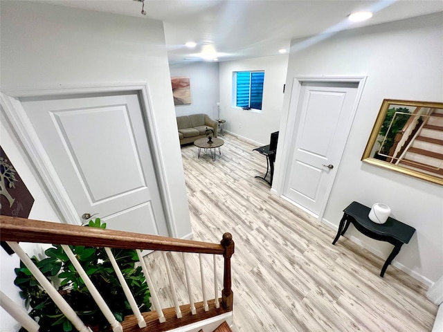 stairway with hardwood / wood-style flooring