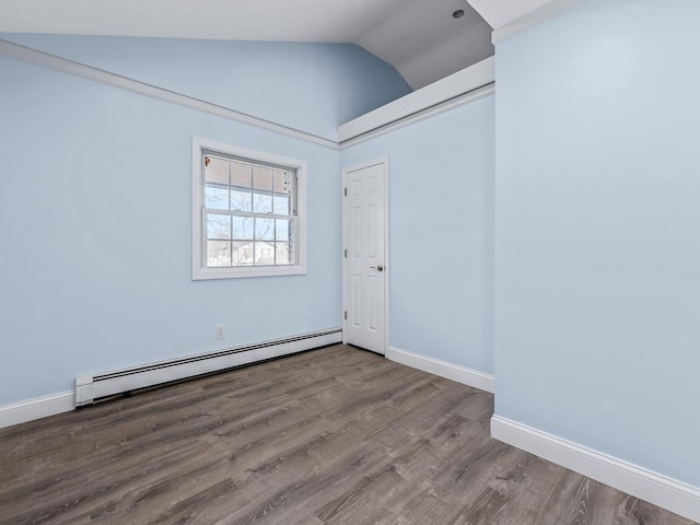 spare room with hardwood / wood-style flooring, high vaulted ceiling, and a baseboard heating unit